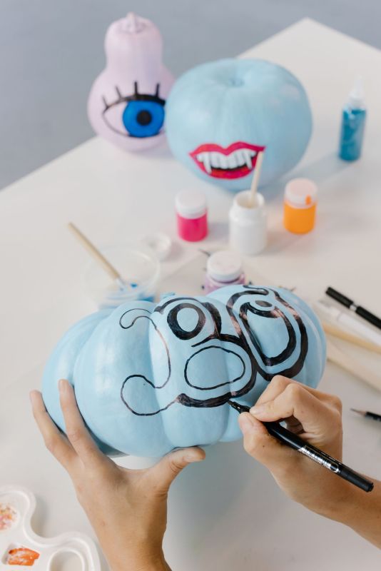A hand-painted pumpkin with colorful designs